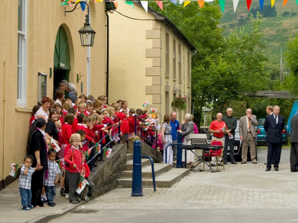 Children in school uniforms outside Victoria hall, Llanwrtyd Wells